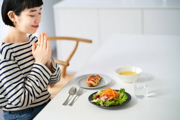 Person pausing mindfully before a nourishing meal